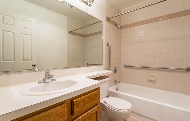 A bathroom with a white sink and a white toilet.