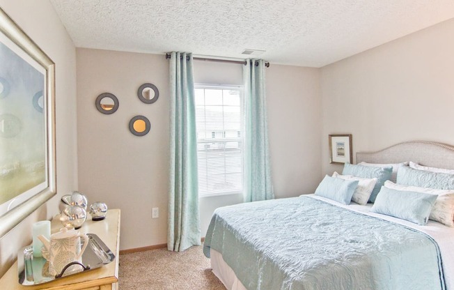 a bedroom with a large bed and a window
