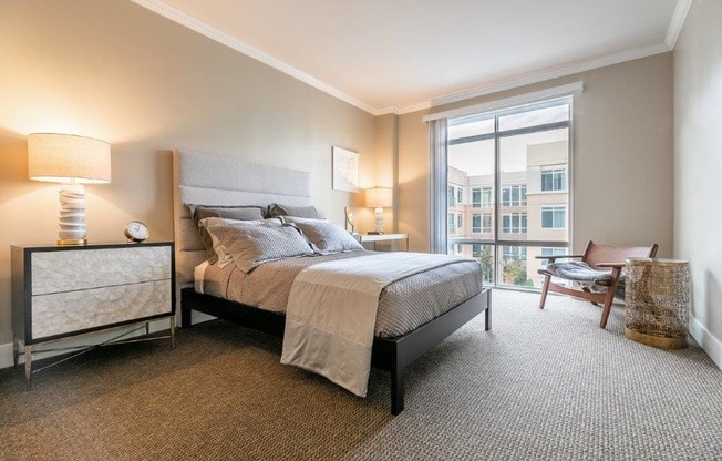 The Mercer Master Bedroom with bed, chair, and window