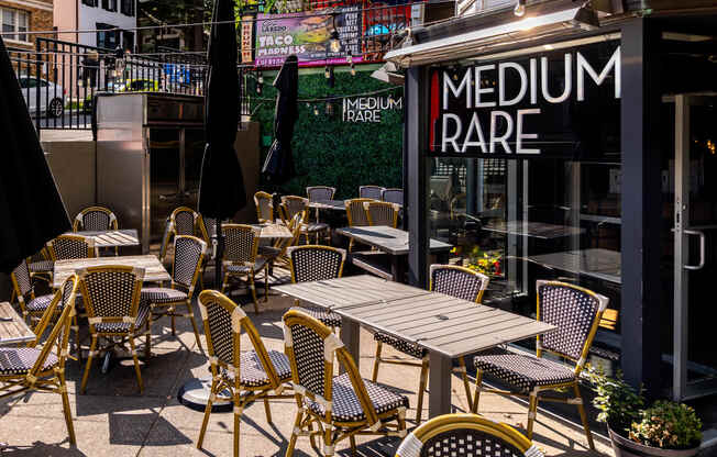 a patio with tables and chairs outside of a restaurant