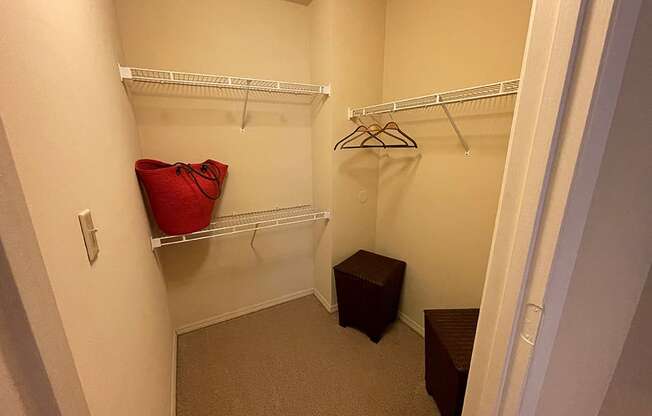 a walk in closet in a bedroom plus den unit at the historic electric building in fort worth