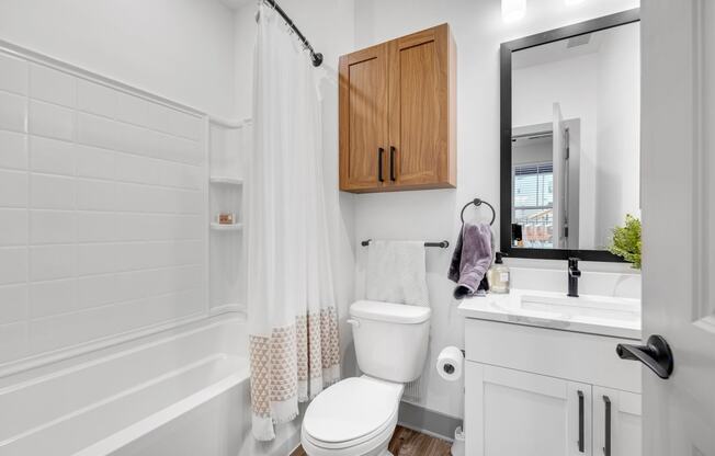 a small bathroom with a toilet and a sink at Meridian at CityPlace, Minnesota