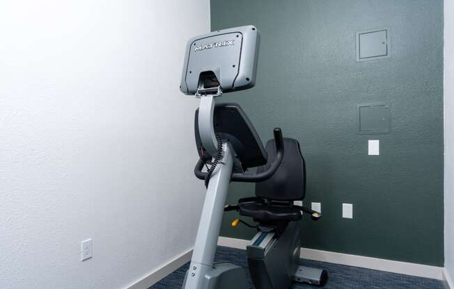 a gym with an exercise bike in a room
