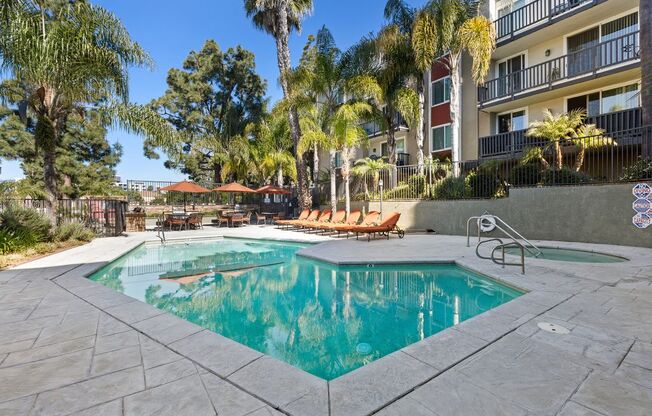 One-BR Apartments In Culver City, CA - Parkway Plaza - Sparkling Swimming Pool With Lounge Chairs, Tables, And Umbrellas