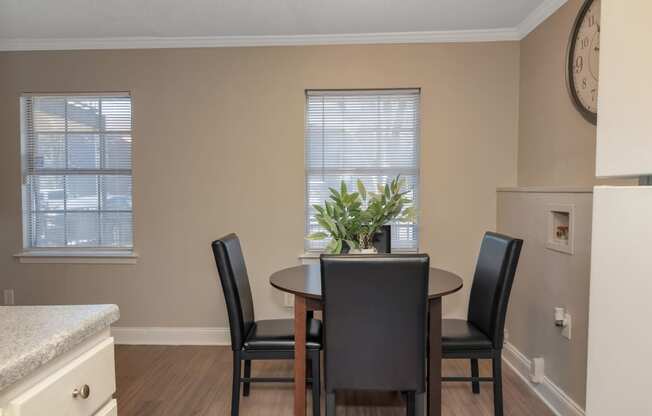 an image of a dining room with a table and chairs