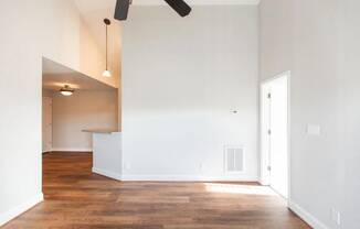 Spacious living area with ceiling fan and hardwood floors  at Huntington Apartments, North Carolina, 27560