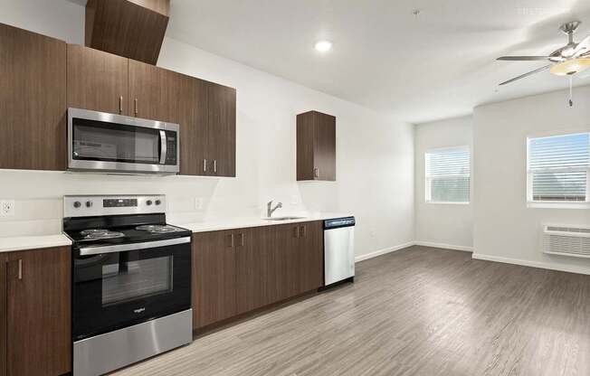 A modern kitchen with wooden cabinets and stainless steel appliances.