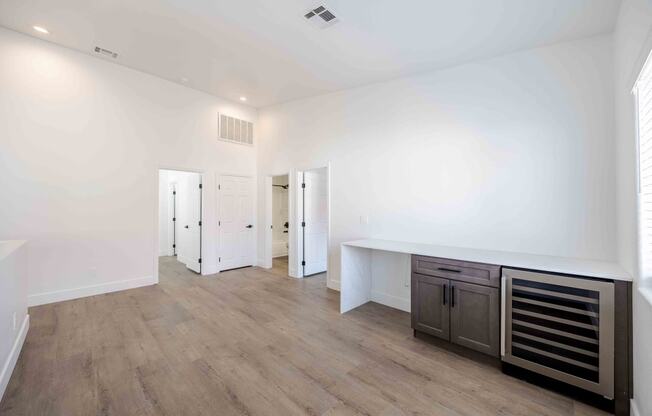 a living room with white walls and a wooden floor