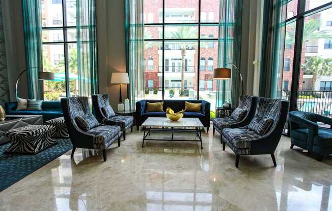 A living room with a large window and a view of a building.