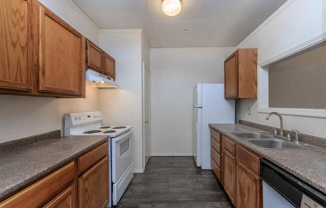 a kitchen with stainless steel appliances and wooden cabinets