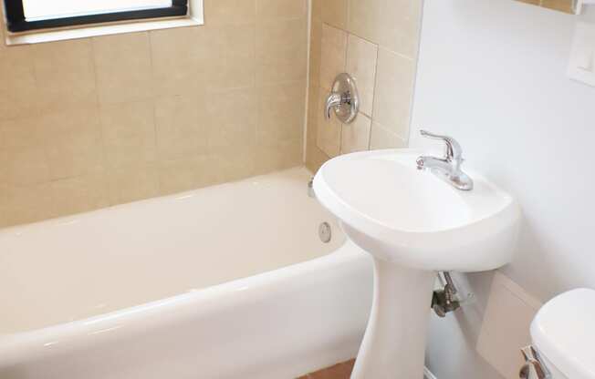 a bathroom with a sink toilet and a bath tub