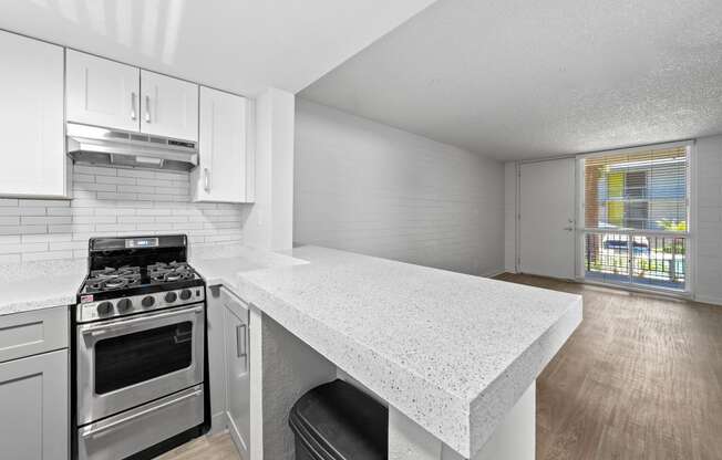 a kitchen with white cabinets and a white counter top