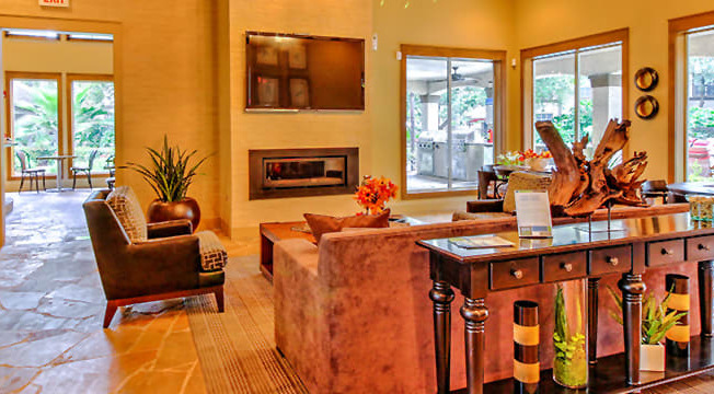 a living room with a couch and a table and a fireplace