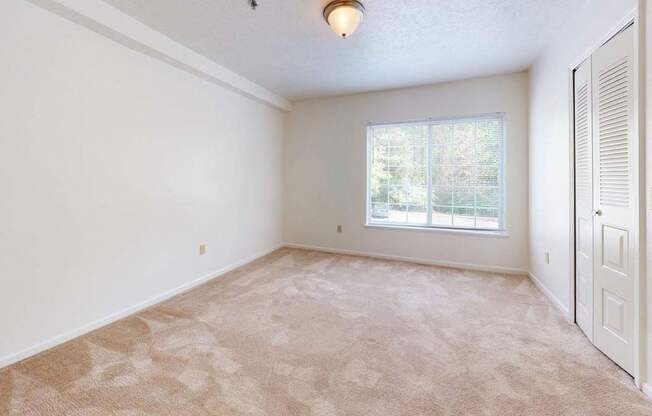 large bedroom with a window and a closet at Fieldstream Apartment Homes, Iowa