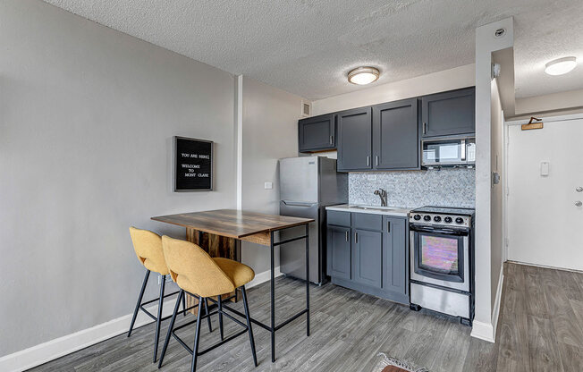 a kitchen with a table and chairs and a refrigerator