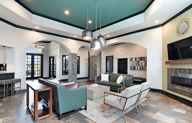 a living room with couches and chairs and a fireplace