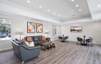 a living room with a couch and a table and chairs