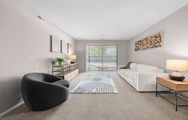 Spacious Living Room with Sliding Glass Door at Lakeside Village Apartments Clinton Township MI