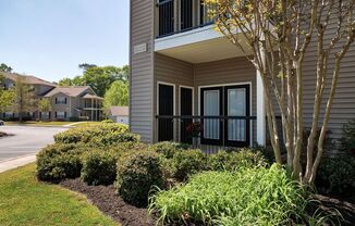 a building with a front door and a landscaped yard