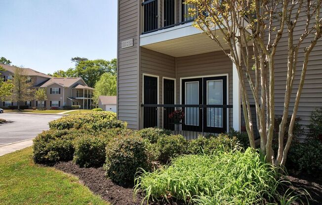 a building with a front door and a landscaped yard
