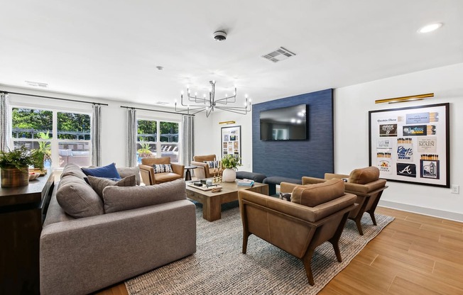 A living room with a grey couch, a brown sofa, a coffee table, and a television.