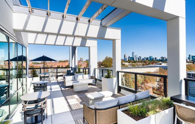Rooftop lounge seating framed by open-air pergolas and skyline views, offering flexible spaces to gather, relax, or enjoy fresh air overlooking downtown Atlanta.