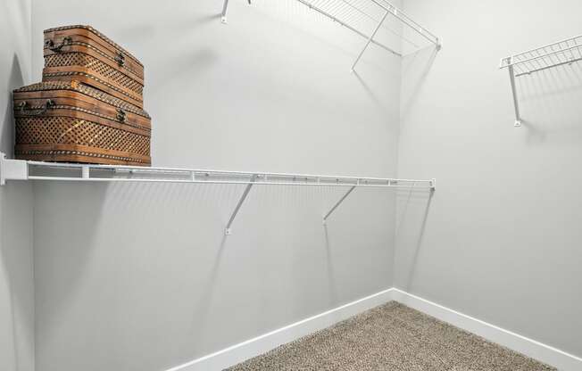 A white shelf with a few boxes on it.