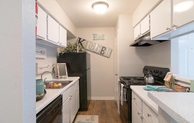 a kitchen with a sink and a refrigerator