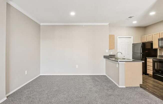 an empty room with a kitchen and a counter top in it