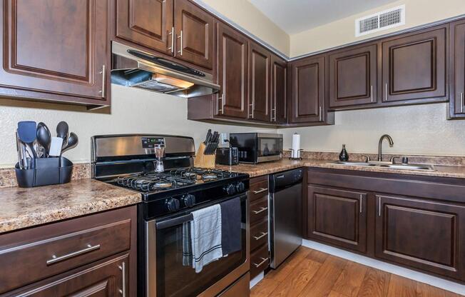 a kitchen with stainless steel appliances and wooden cabinets