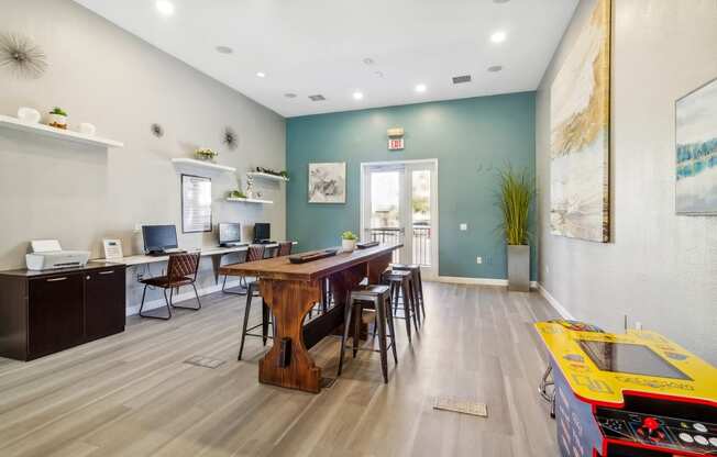 the preserve at ballantyne commons community room with tables and chairs and a desk