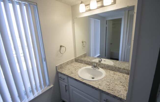 This is a photo of the bathroom vanity in the 500 square foot 1 bedroom apartment at Harvard Square Apartments, in Dallas, TX.