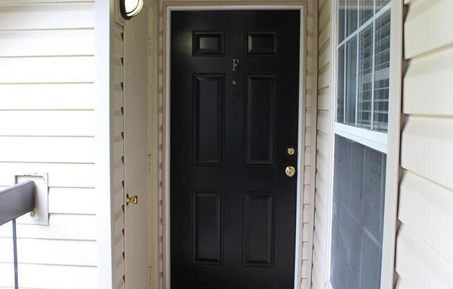 a black door on a white house