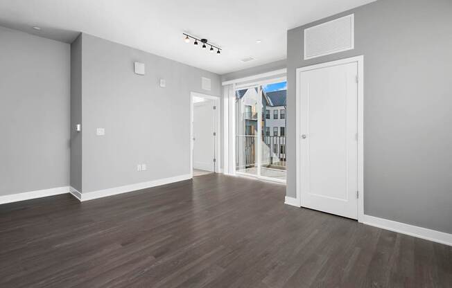 A room with a white door and a window.