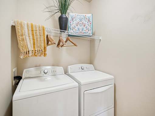 In-home washer and dryer area at Village at Broadstone Station apartments in Apex, NC