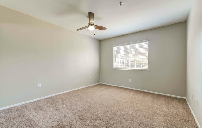bedroom with carpet and ceiling fan at Cypress Villas Apartments