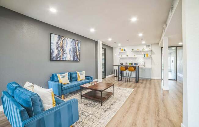 a living room with blue couches and a coffee table