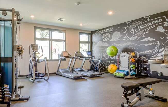 a workout room with cardio equipment and a chalkboard wall in a home gym at Woodcreek, Washington
