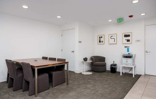 a conference room with a table and chairs and a refrigerator