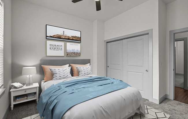 a bedroom with a bed and a ceiling fan