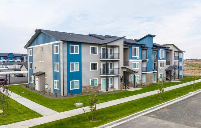 a row of new apartment buildings next to a street