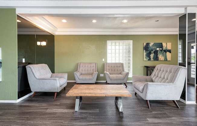 a waiting room with four chairs and a coffee table