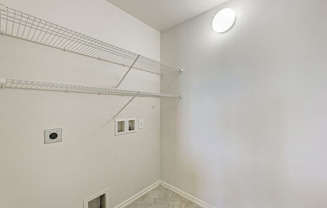 A white wall with a light on it.