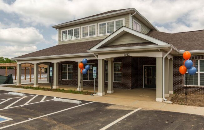 the front of a building with balloons outside of it