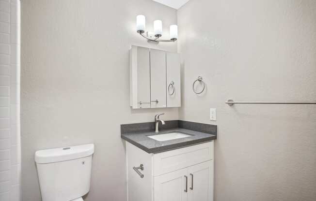 a white bathroom with a sink and a toilet