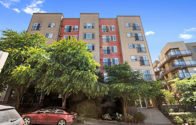 Street View of property building with landscaped trees for shade at Illumina Apartment Homes, Seattle, WA