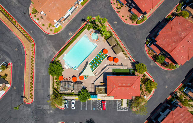 A view of a roundabout with a pool and a building in the middle.
