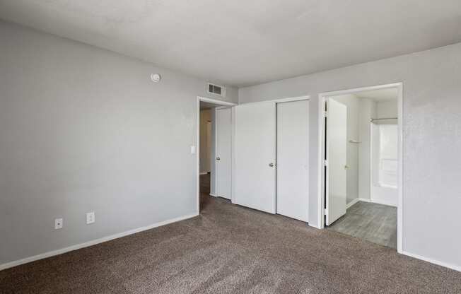 A room with carpeted floor and white walls.