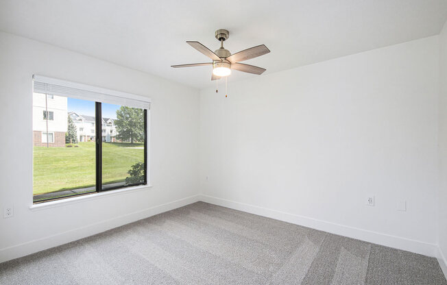 Spacious bedroom with large window at The Crossings Apartments, Grand Rapids, Michigan