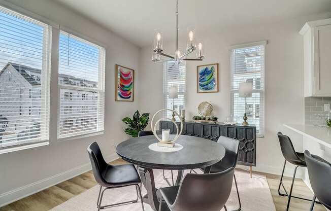 A dining room with a round table and chairs.